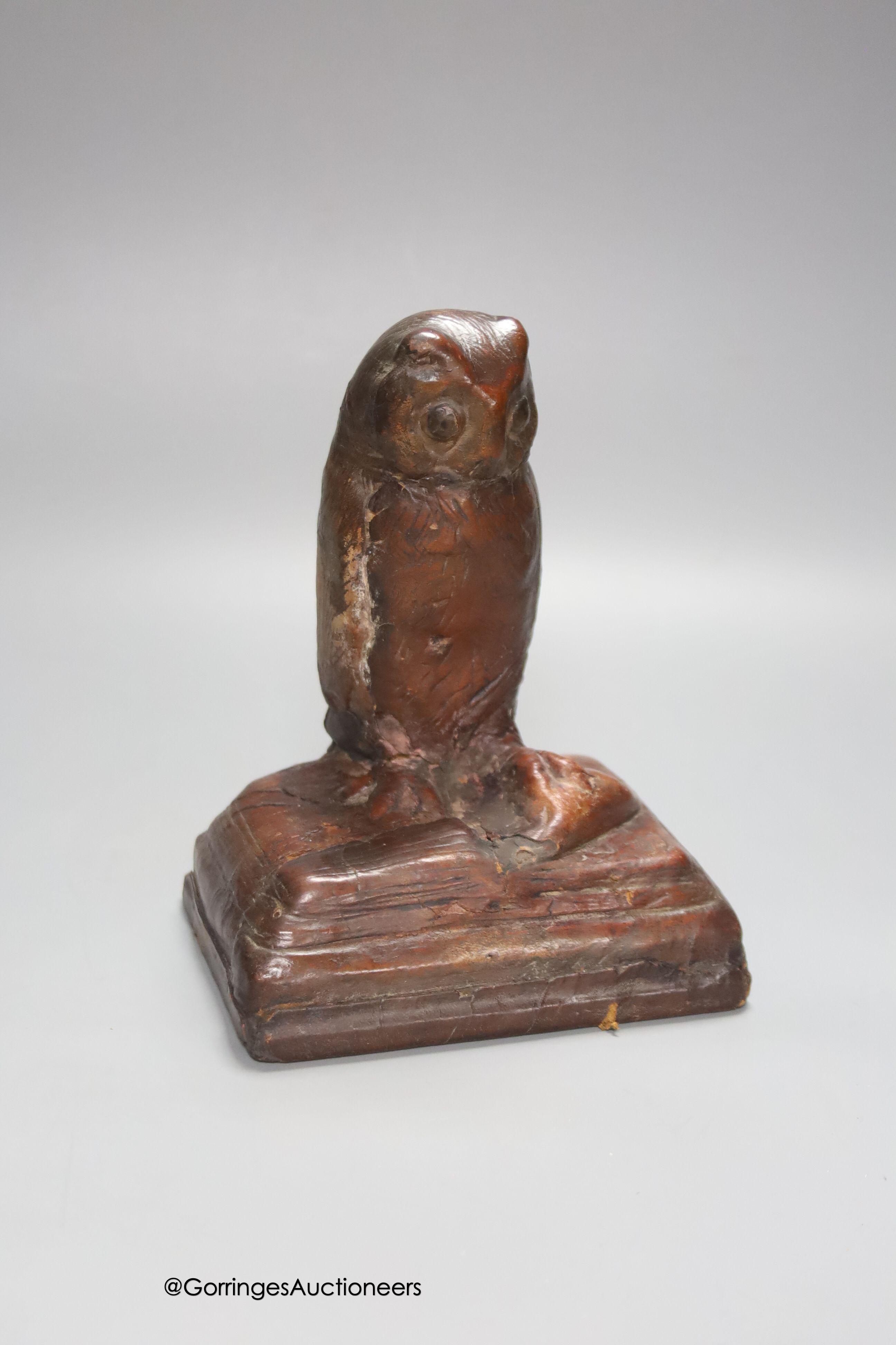 A handmade leather owl, signed H.E. Jackman MC, signed and inscribed underside, height 18cm, repaired